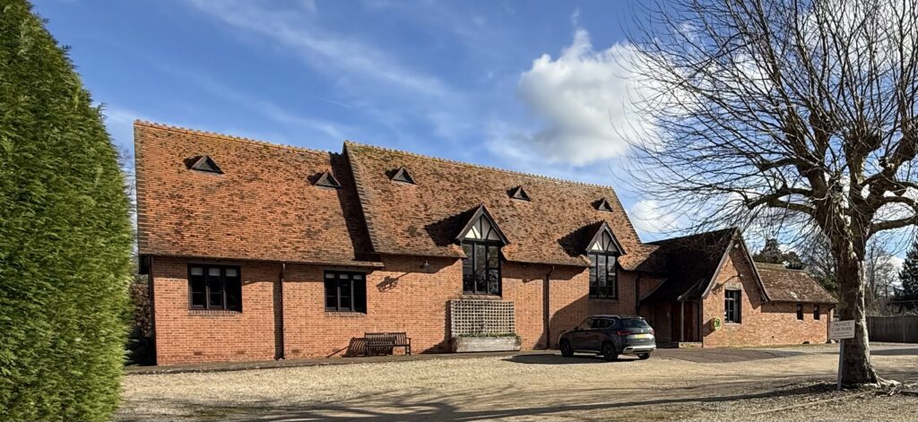 Exterior of Loyd Lindsay Rooms with extensive parking for visitors